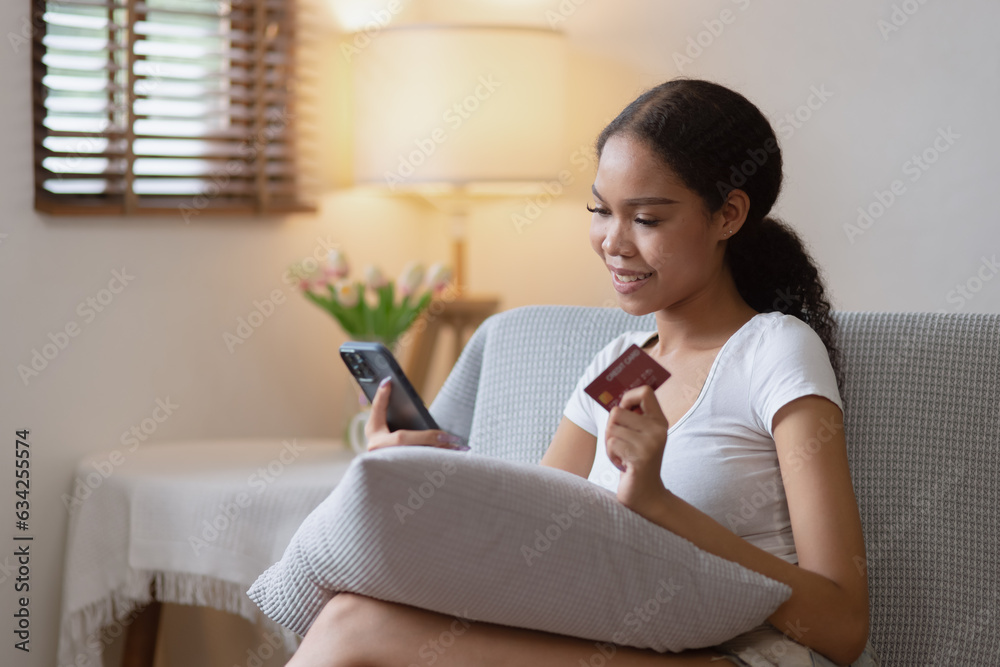 Young African woman smartphone with credit card at home, Online Shopping. Young African woman smartphone with credit card at home, Online Shopping.