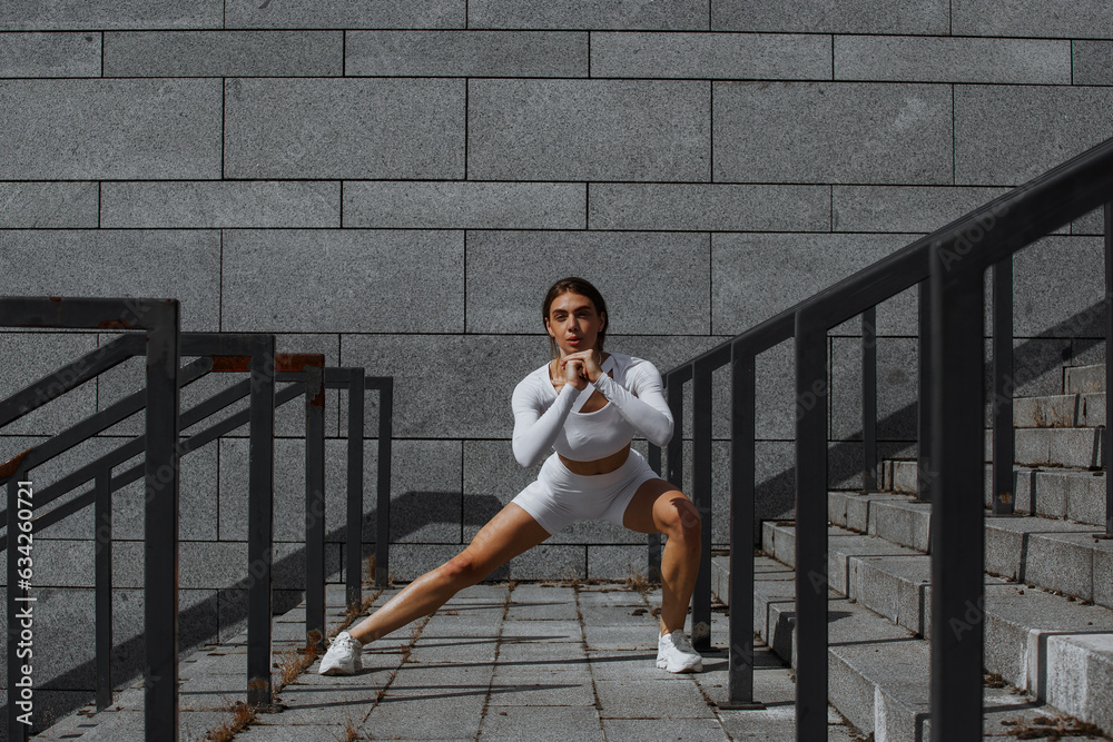 Sporty girl performs functional training on the street. Sporty girl performs functional training on the street.