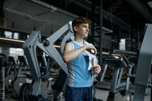Portrait of teenager boy feeling satisfied after good training at gym