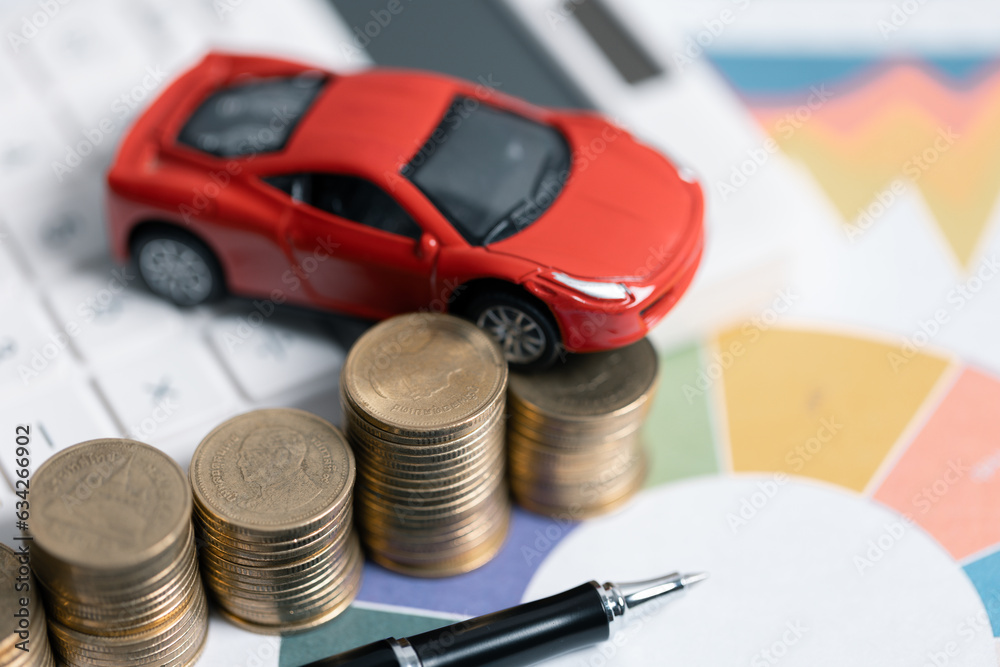 Miniature car model and Financial statement with coins. Finance and car loan, saving money for a car concepts. Car loan, money, banknote on agreement document or car insurance application form. Miniature car model and Financial statement with coins. Finance and car loan, saving money for a car concepts. Car loan, money, banknote on agreement document or car insurance application form.