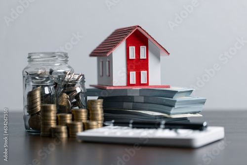 Loan application form paper with money coin and loan house model on table, Loan business finance economy commercial real estate investments. Home loan concept.