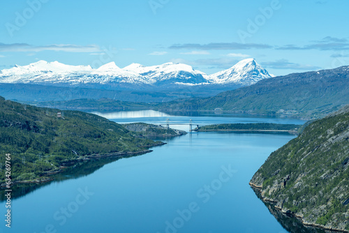 Scenic fjords in Norway with bridge and snow covered mountains