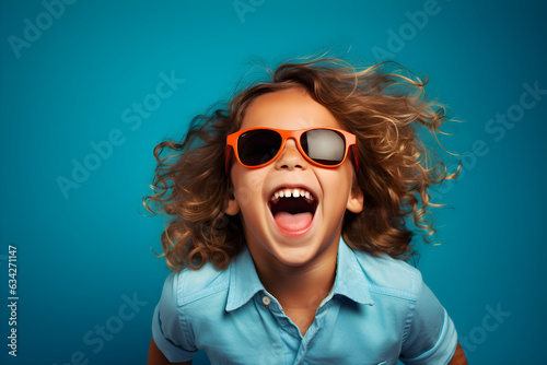 portrait of young girl wearing sunglasses laughing