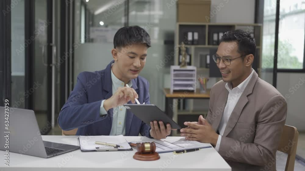 Lawyers, legal advisors and Asian businessman explaining deal details Business contract with investors and brainstorming Make a note in the document before signing the joint contract. Lawyers, legal advisors and Asian businessman explaining deal details Business contract with investors and brainstorming Make a note in the document before signing the joint contract.