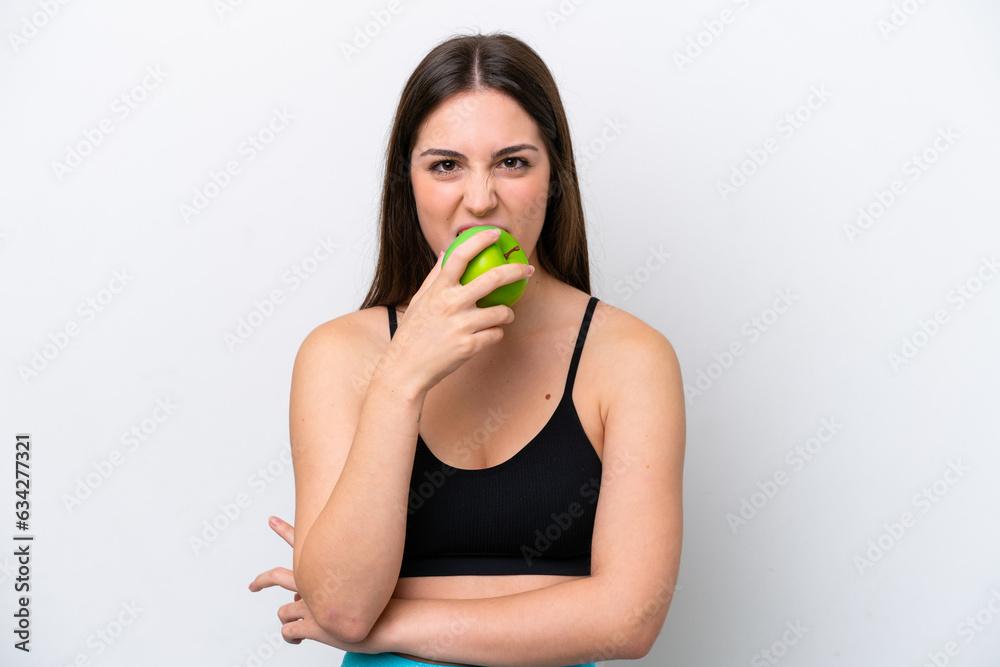 Young girl isolated on white background eating an apple Young girl isolated on white background eating an apple