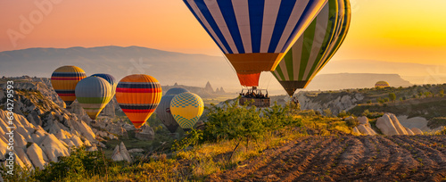 Hot air balloons flying over the valley at Cappadocia, Turkey.