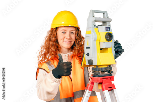 Red hair Woman in yellow hardhat and orange ppe surveyor working with modern surveying geodesic instrument tacho meter checking coordinates. Young woman working in construction industry concept