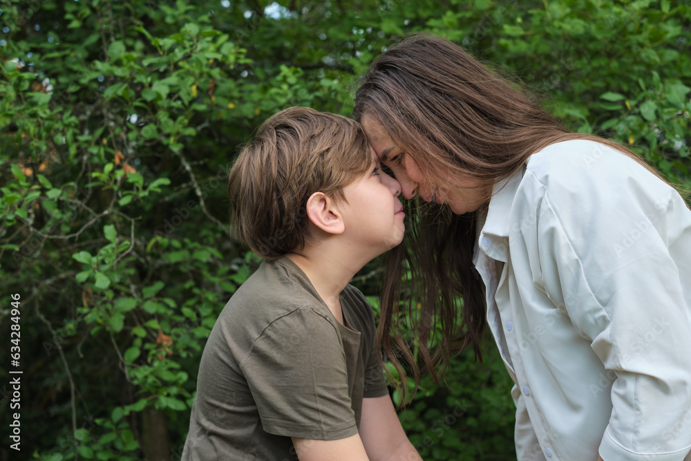 An authentic image of a mother and her pre-teen son in a garden, reflecting the values of childhood and family bonding for social initiatives An authentic image of a mother and her pre-teen son in a garden, reflecting the values of childhood and family bonding for social initiatives