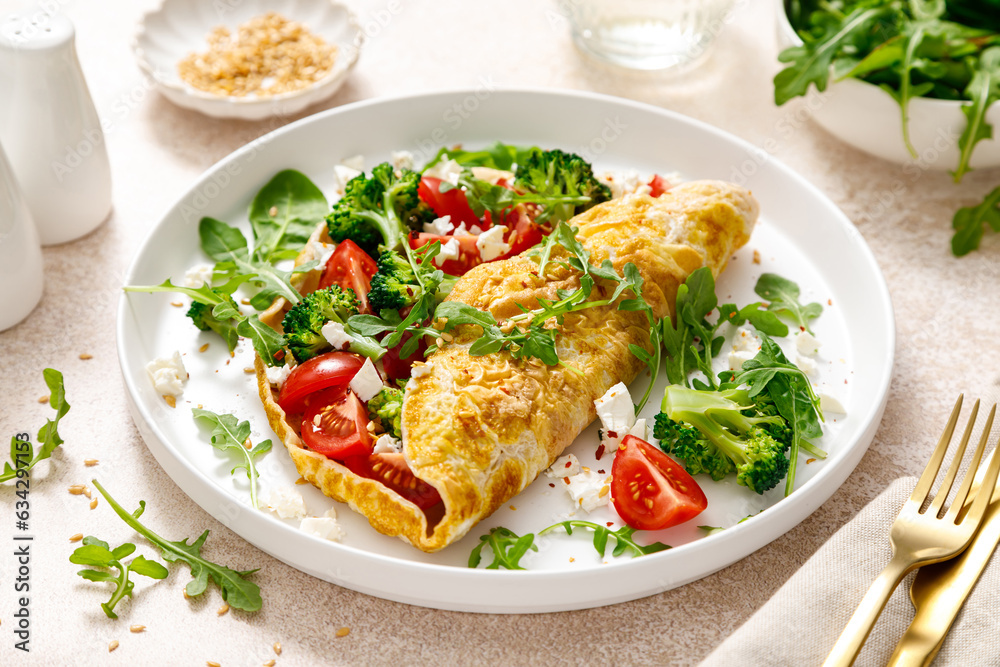 Omelette stuffed with tomato, broccoli feta cheese and fresh green salad. Healthy diet food for breakfast Omelette stuffed with tomato, broccoli feta cheese and fresh green salad. Healthy diet food for breakfast