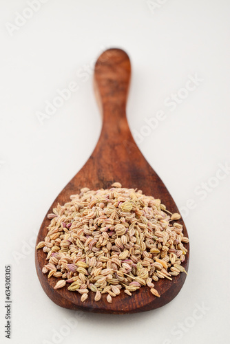 Closeup of carom seeds in wooden spoon photo