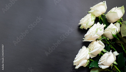 Fresh, white roses on black, dark background. Condolence card. Empty place for emotional, sentimental text, quote or sayings. Top view. Flat lay.