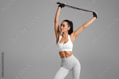 Fitness woman with skipping rope training. Athletic girl