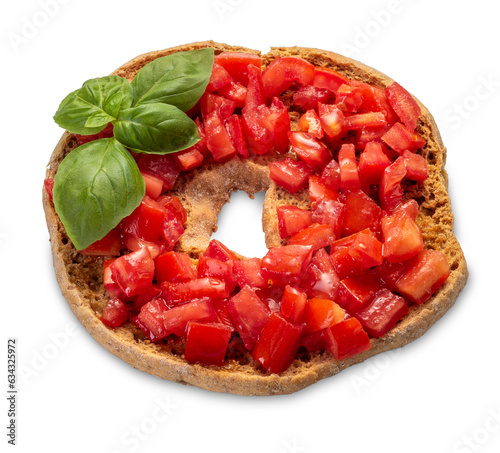 Italian dry bread friselle with chopped cherry tomatoes and basil leaves dressed with olive oil poured from oil bottle - isolated photo