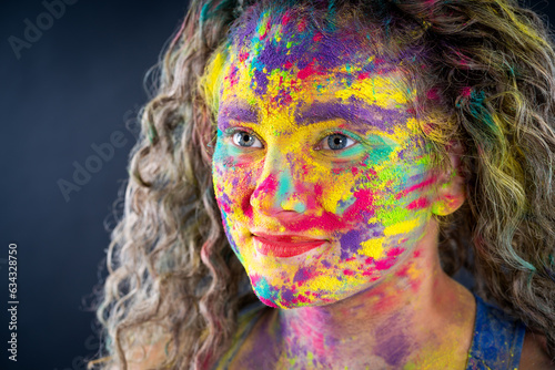 Bodypainting, creative makeup, bright colorful body art on gray background, plus size fat woman painted with powder paints