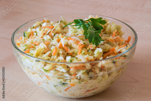 Vegetables salad with cabbage, carrot and cucumber in a bowl. Healthy food.