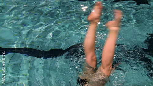 Synchronized swimmer during training on the pool upside down photo