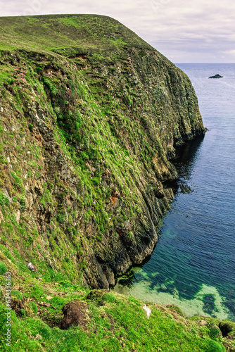 Rock formation by the sea on Fair isle in the atlantic ocean photo