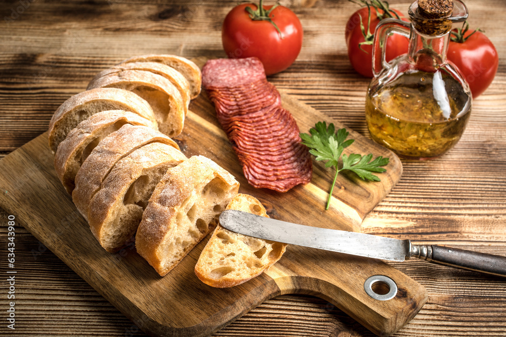 Italian ciabatta bread cut in slices with salami. Italian ciabatta bread cut in slices with salami.