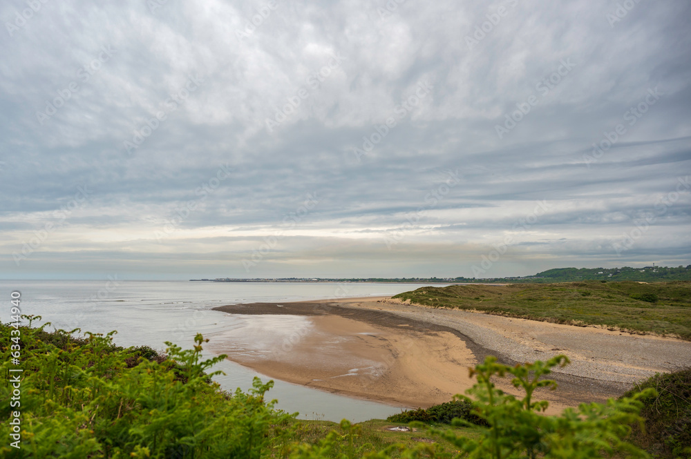 View along the south Wales coastline, towards the town of Porthcawl, from Ogmore. The day is cloudy