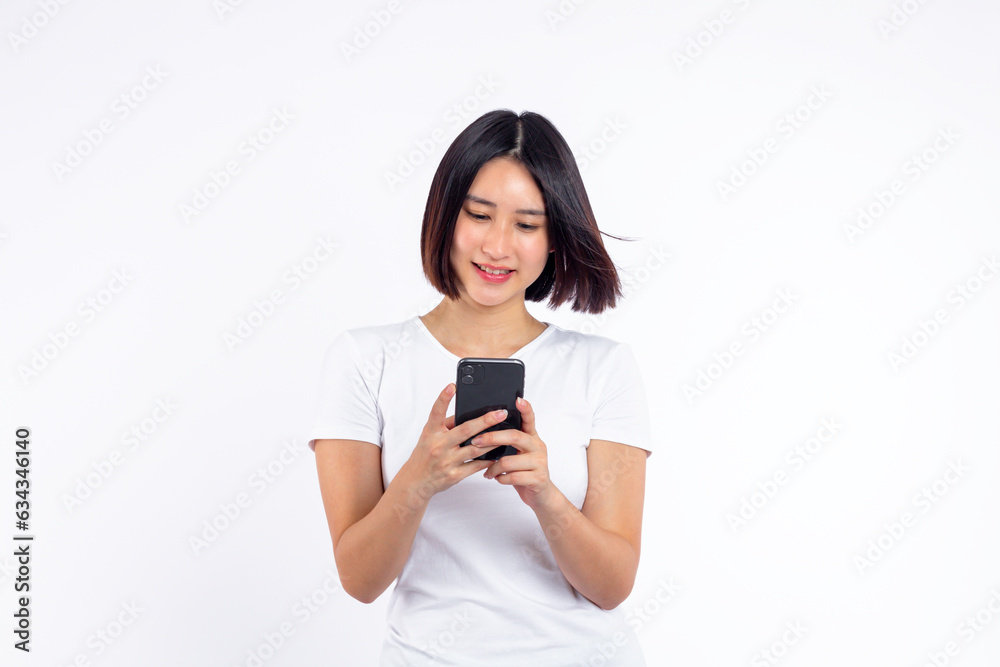 Young woman of asian smiling face beautiful holding smartphone and smiling with typing on mobile, isolated on white background.