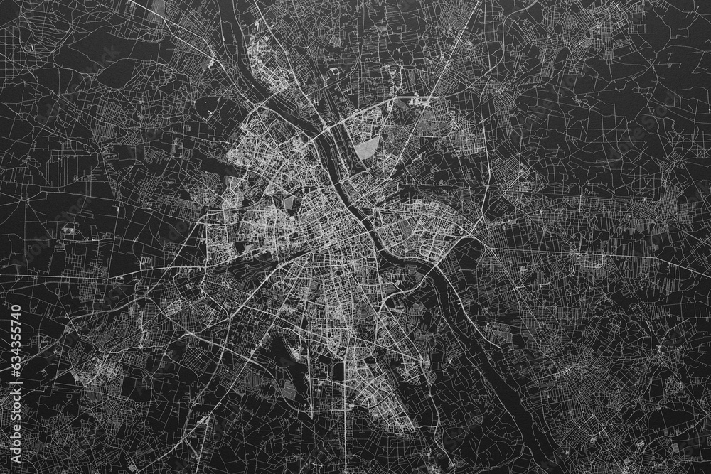 Street map of Warsaw (Poland) on black paper with light coming from top