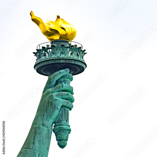 New York, New York, United States. August 07, 2023. Dramatic and detailed image of the Statue of Liberty with strong shades of green, sky with many clouds and very high resolution. photo