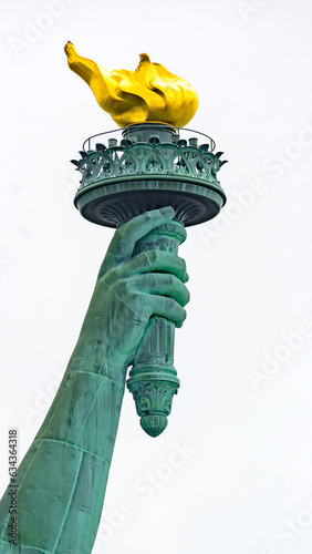 New York, New York, United States. August 07, 2023. Dramatic and detailed image of the Statue of Liberty with strong shades of green, sky with many clouds and very high resolution.