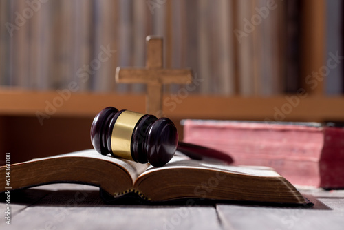 Holy bible book and judge's gavel on table background. Judicial system, constitution, democracy, rule of law. There are no people in the photo. There is free space to insert.