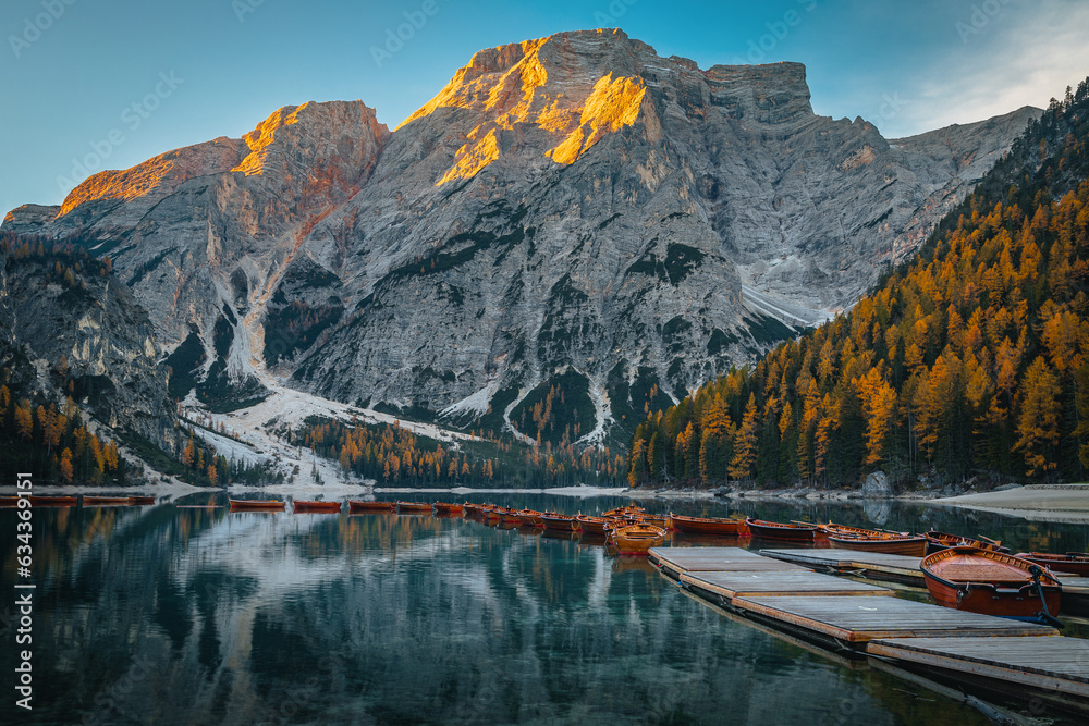 Fototapeta Anchored wooden boats on the lake Braies at sunrise, Dolomites
