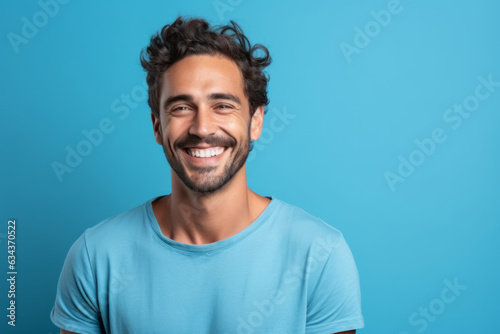 Smiling Caucasian Man with a Charming Portrait on a Blue Studio Background