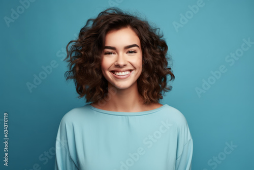 Joyful Caucasian Woman Radiating Happiness on Vibrant Blue Studio Background