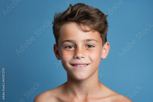 Cheerful Caucasian Boy with Infectious Smile on Vibrant Blue Studio Background