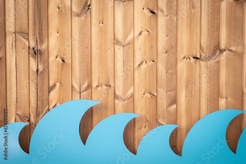 Wooden texture background with blue waves made of cardboard. Summer beach cafe or bar wall decoration. Surfing spot creative design. Ocean, seafood restaurant, seasonal decor concept. Copy space