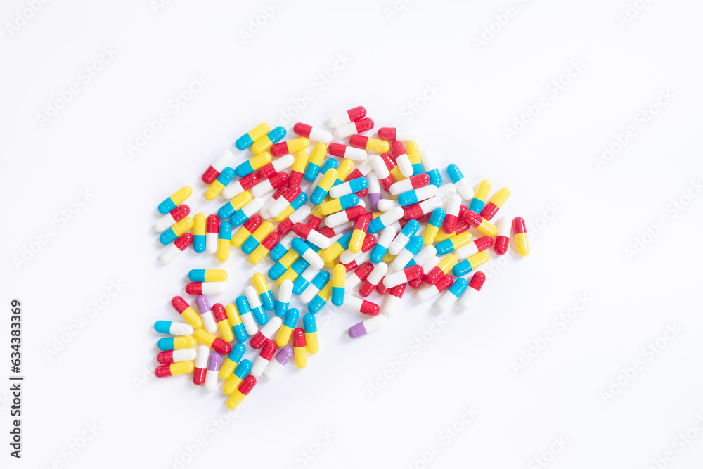 Multicolored tablets lie on a white background. 