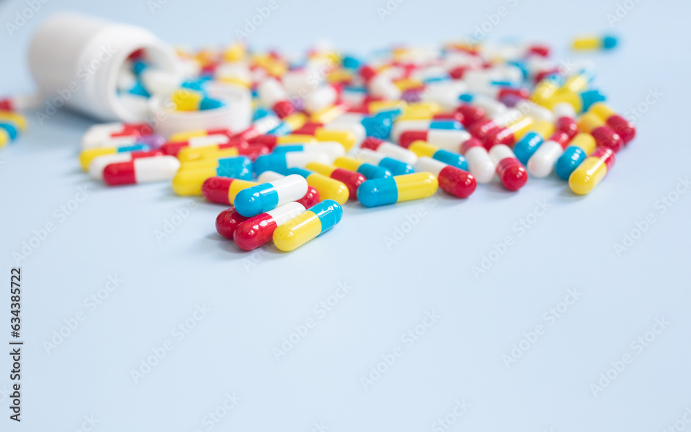 Different kinds of pills, drugs in different colours on blue background. Top view, flat lay. Different kinds of pills, drugs in different colours on blue background. Top view, flat lay.
