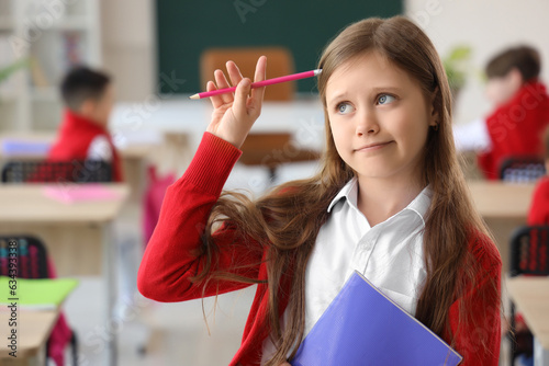 Thoughtful little schoolgir...