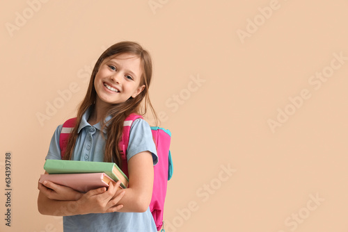 Little schoolgirl with book...