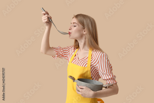 Young woman with ladle and ...