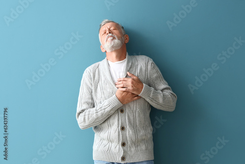 Mature man having heart att...