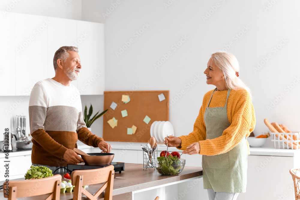 Mature couple cooking in kitchen Mature couple cooking in kitchen