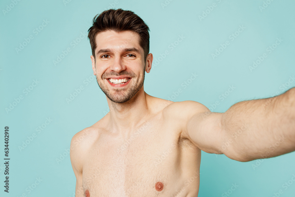 Close up happy young man wear shorts swimsuit relax near hotel pool doing selfie shot pov on mobile cell phone isolated on plain light blue cyan background. Summer vacation sea rest sun tan concept.