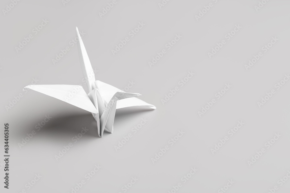 Origami crane on grey background Origami crane on grey background