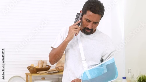 Hispanic businessman with mustache stays at home cannot work during broken arm accident talk to medical specialist for treatment process, freelancer male calls insurance agent for compensation claim