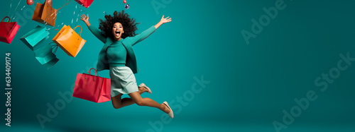 Joyful happy Woman Shopping. Shopping bags and confetti on a studio background. Concept of Shopping, Retail, Sale, Black Friday or Cyber Monday.