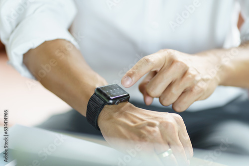 Business man Looking at smart watch In Office online connect Gadget technology