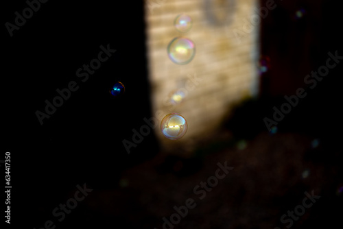 Some blurred and sharp soap bubbles on a light and dark background