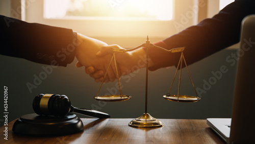 Businessman shaking hands to seal a deal with his partner lawyers or attorneys discussing a contract agreement