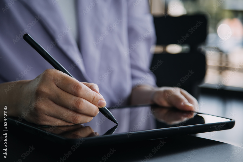 Asian Business woman using calculator and laptop for doing math finance on an office desk, tax, report, accounting, statistics, and analytical research concept Asian Business woman using calculator and laptop for doing math finance on an office desk, tax, report, accounting, statistics, and analytical research concept