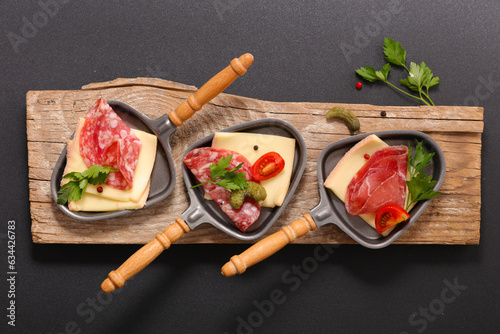 raclette cheese trays and differents sorts of meats- Traditional French winter food