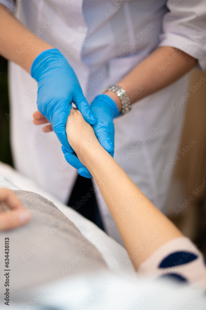 close-up of a massage therapist doing a hand massage in a beauty salon